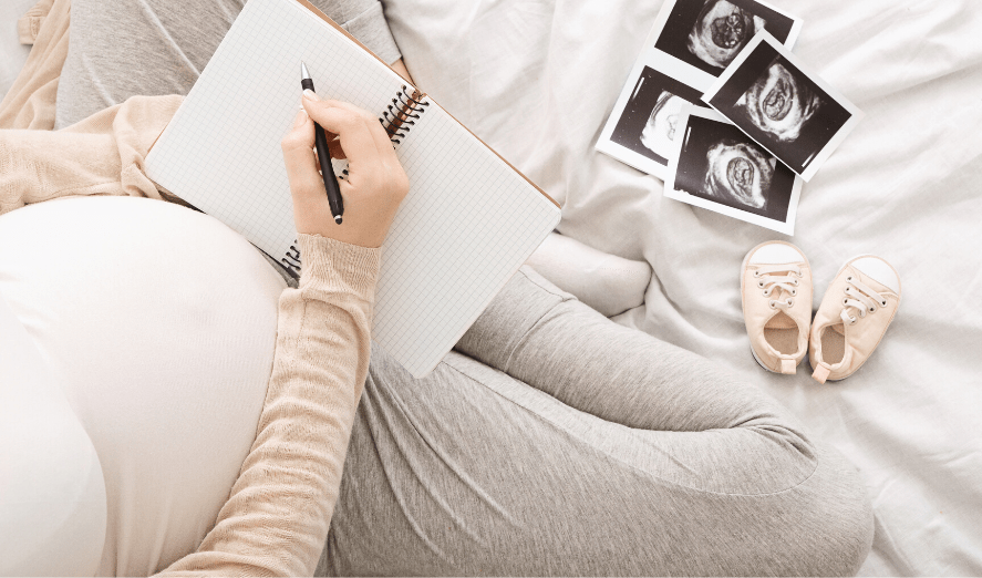 pregnant mom writing in journal