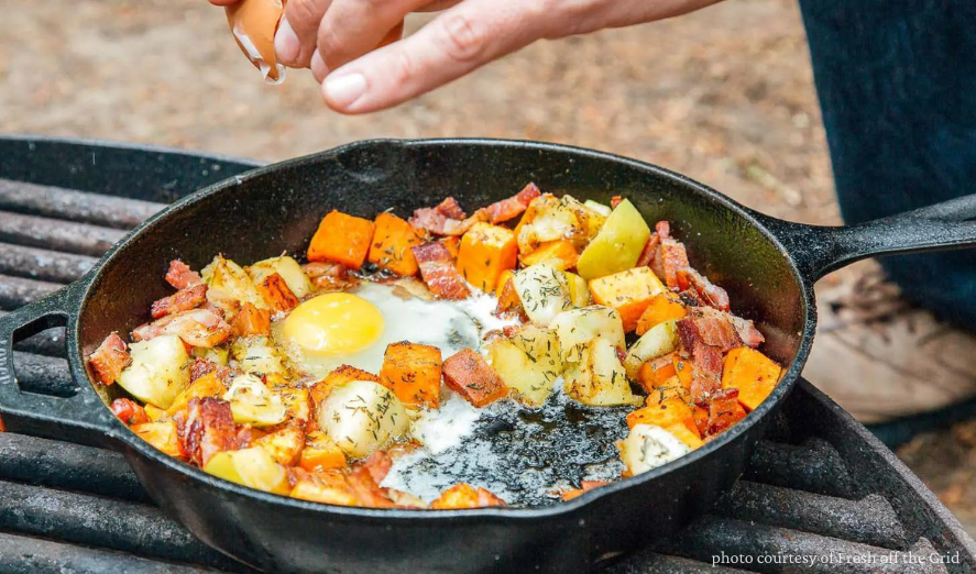 Camping Meal in cast iron skillet over campfire