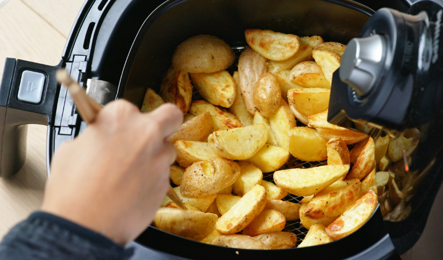 air fryer with potato wedges inside